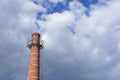 Tall old brick chimney against cloudy sky Royalty Free Stock Photo