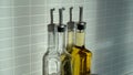 Tall olive oil bottles and various spice jars in the kitchen Royalty Free Stock Photo
