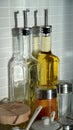 Tall olive oil bottles and various spice jars in the kitchen Royalty Free Stock Photo