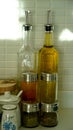 Tall olive oil bottles and various spice jars in the kitchen Royalty Free Stock Photo