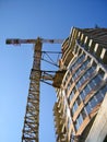 Tall orange crane constructing a new business building