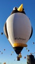The Tall Penguin Air Balloon floats above in the Fiesta