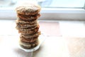 Tall pile of used teabags on a teabag shaped plate, on a kitchen windowsill Royalty Free Stock Photo