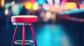 Tall pink bar stool on blurred background of pub neon lights