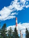 Tall pipes of a plant against a blue sky Royalty Free Stock Photo