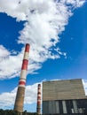 Tall pipes of a plant against a blue sky Royalty Free Stock Photo