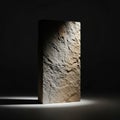 A tall, rectangular stone block stands upright on a dark, smooth surface Royalty Free Stock Photo