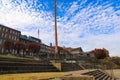 Tall red brick buildings with boarded up and broken windows along the riverfront with gorgeous autumn colored trees Royalty Free Stock Photo