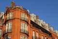 Tall red building with numerous windows and balconies in London Royalty Free Stock Photo