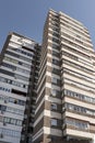 A tall residential apartment building with a brown brick facade Royalty Free Stock Photo