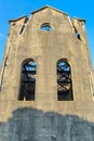 Tall, ruined industrial building with long arched windows Royalty Free Stock Photo