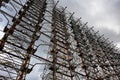 Tall rusty edifices featuring a complex network of wires. Duga is a Soviet over-the-horizon radar station for an early detection