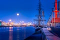 Tall ship anchored on Dublin docks on Liffey river at blue hour with full moon