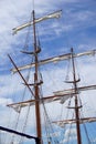 Tall ship mast with rolled sails, sky in background Royalty Free Stock Photo