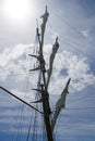 Tall ship mast with rolled sails, sky in background Royalty Free Stock Photo