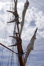 Tall ship mast with rolled sails, sky in background Royalty Free Stock Photo