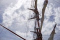 Tall ship mast with rolled sails, sky in background Royalty Free Stock Photo