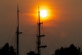 Tall ship rigging and flying bird silhouetted against fiery sunset Royalty Free Stock Photo