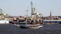 Tall ship underway in New York harbor, Brooklyn-side industrial Columbia Street Waterfront in the background Royalty Free Stock Photo