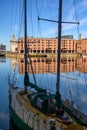 Tall shot of the Albert Dock in Liverpool through the rigging of a small boat moored at the side