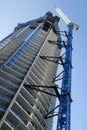 Tall skyscraper high rise building construction with crane, vertical