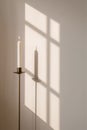 Elegant Candle Holder Casting Diagonal Shadow on Pale Wall Royalty Free Stock Photo