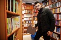 Tall smart arab student man at library