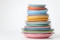 Pile of Dirty Dishes Accumulated Over the Week on a Plain White Background Showing Various Colors and Sizes of Plates and Bowls Royalty Free Stock Photo