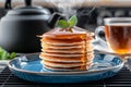 Tall stack of pancakes with maple syrup and mint, pancakes showcase height, pancakes inspire breakfast ads, pancakes Royalty Free Stock Photo