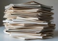 A tall stack of sealed envelopes rests on a smooth, white surface. The envelopes vary Royalty Free Stock Photo