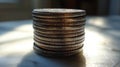 Silver coins stacked on a wooden surface illuminated by sunlight in a minimalist setting Royalty Free Stock Photo