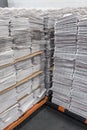 Tall stacks of newspapers on pallets