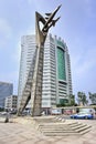 Tall statue with office building on background, Yantai, China