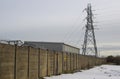 A tall steel electricity pylon with high voltage power cables that is part of the local grid supply network