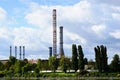 tall steel industrial smoke stacks. old, decommissioned powerplant. blue sky and white clouds.