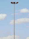 Tall steel lamp in the park on blue sky in background. Stadium light, spot light pole Royalty Free Stock Photo