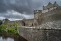 Tall stone walls and moat of 11th century Cahir castle in Cahir town Royalty Free Stock Photo