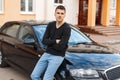 Handsome man in a black T-shirt near the car Royalty Free Stock Photo