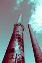 Tall surreal industrial smokestack factories produce smoke, concept of futuristic future and environmental pollution