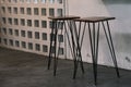 Tall table - Wooden table steel legs simplistic, tall bar stools in stylish kitchen with wooden cupboards.