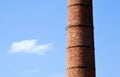 large brick chimney stack closeup. rusty metal reinforcing straps. abstract view