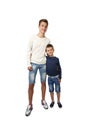 Tall teenager and little boy stand together embracing