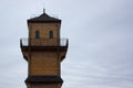 A tall tower made of wooden beams against a cloudy autumn sky. A tall structure with windows and bridges Royalty Free Stock Photo