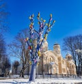 Tall tree with many colorful birdhouses