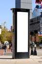 Tall, vertical billboard on phone booth Royalty Free Stock Photo