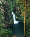 A tall waterfall pours over the cliffs