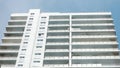 A tall white building with a blue sky in the background Royalty Free Stock Photo
