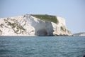 Tall white cliffs towering above a blue sea