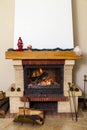 Tall white fireplace with fire in hearth