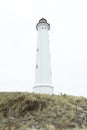 White lighthouse on the ocean Royalty Free Stock Photo